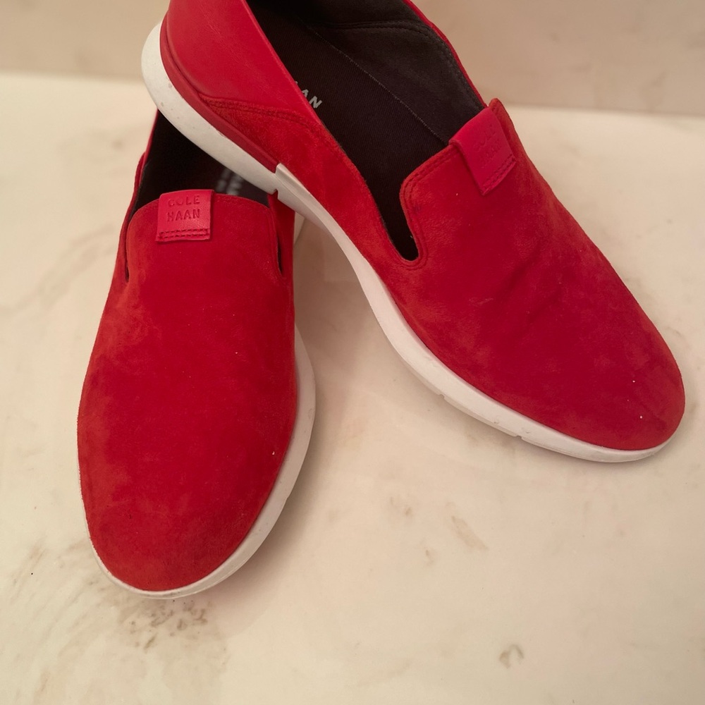 Cole Haan red suede and leather slip on flats.